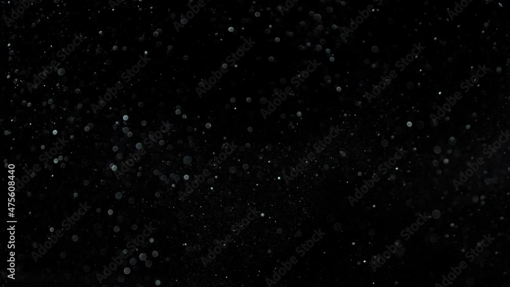 Super Slow Motion Shot of Silver Glittering Particles Isolated on Black Background at 1000 fps. Super Slow Motion Shot of Silver Glittering Particles Isolated on Black Background at 1000 fps.