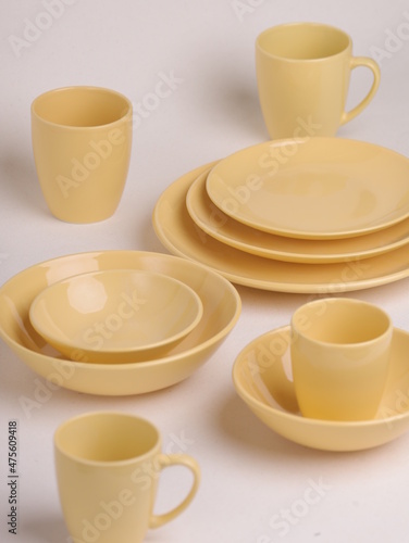 set of yellow ceramic dishes on a light background