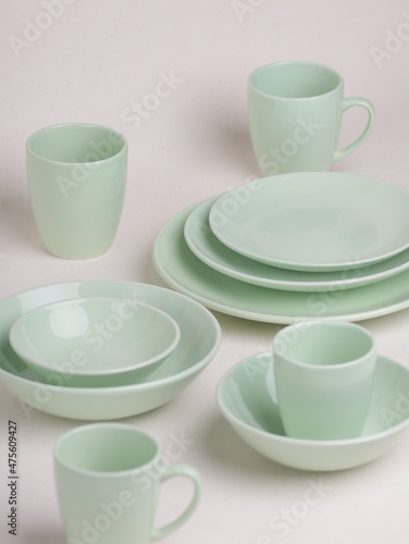 set of green ceramic dishes on a light background