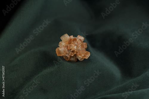 Orange aragonite crystal on green velvet 2