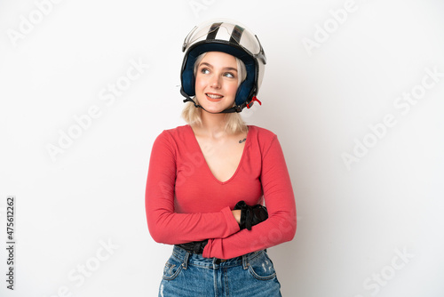 Young caucasian woman with a motorcycle helmet isolated on white background thinking an idea while looking up © luismolinero