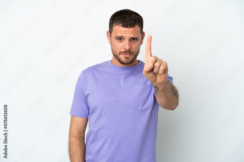 Young Brazilian man isolated on white background counting one with serious expression Young Brazilian man isolated on white background counting one with serious expression