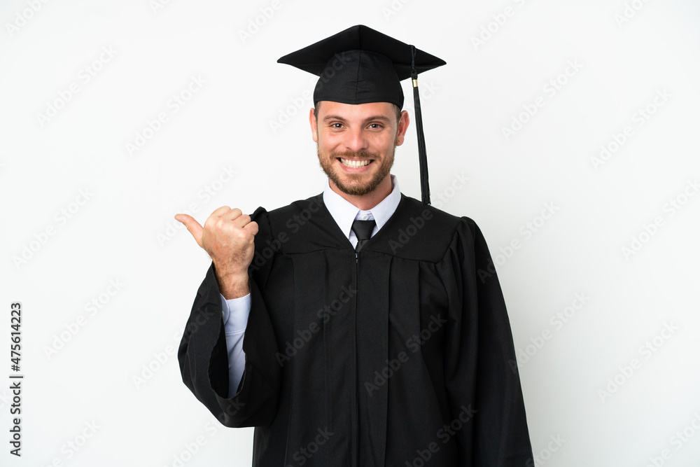 Young university Brazilian graduate isolated on white background pointing to the side to present a product Young university Brazilian graduate isolated on white background pointing to the side to present a product