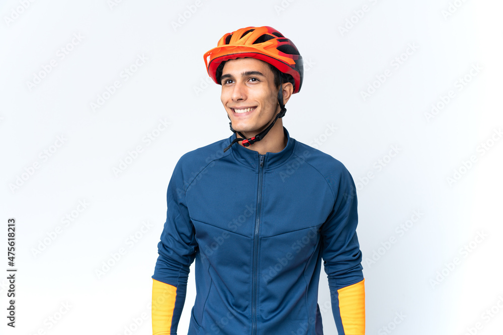 Young cyclist man isolated on background thinking an idea while looking up Young cyclist man isolated on background thinking an idea while looking up