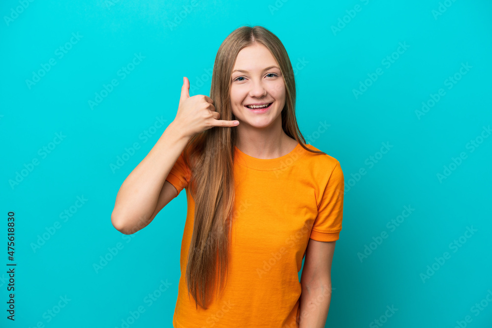 Young Russian woman isolated on blue background making phone gesture. Call me back sign Young Russian woman isolated on blue background making phone gesture. Call me back sign