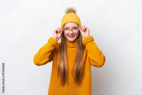 Young caucasian woman wearing winter jacket isolated on white background with glasses and surprised © luismolinero