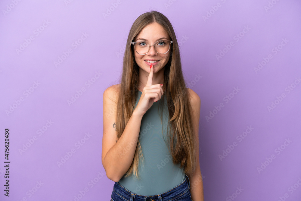 Young Lithuanian woman isolated on purple background showing a sign of silence gesture putting finger in mouth Young Lithuanian woman isolated on purple background showing a sign of silence gesture putting finger in mouth