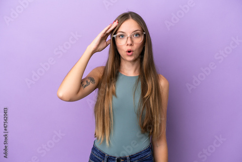 Young Lithuanian woman isolated on purple background has realized something and intending the solution