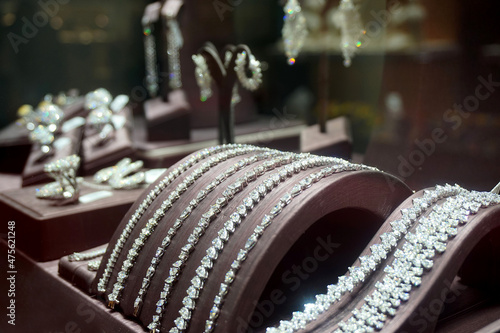 Gold jewelry diamond shop with rings and necklaces luxury retail store window display showcase