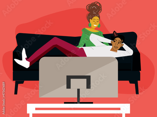 Lesbian couple relaxing on the couch watching televisi photo