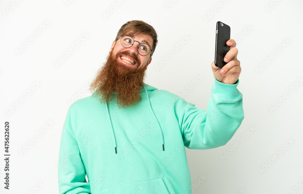 Young reddish caucasian man isolated on white background making a selfie Young reddish caucasian man isolated on white background making a selfie