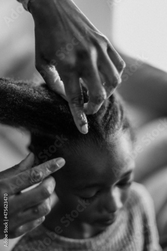 Black Girl getting hair braided © Matelli Graves