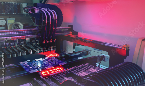 фотографія SMD Assembly of electronic components on a motherboard by an automated Pick and Place robot