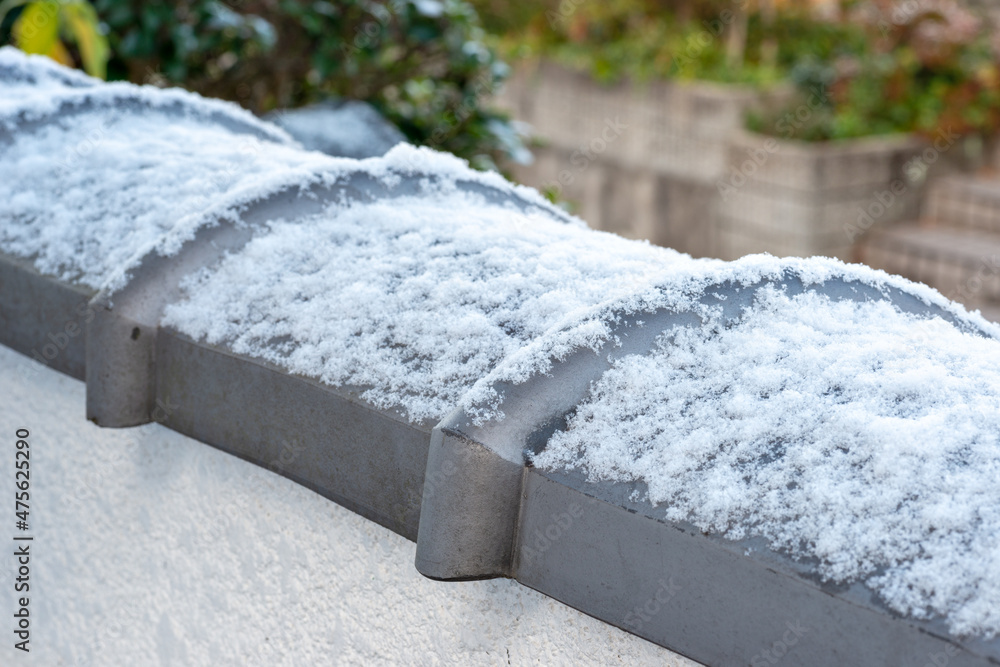 Fence tile lightly dusted with snow in Japan