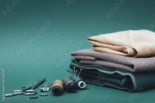 Wallpaper Mural Sewing tools. Sewing kit. Scissors, bobbins with thread, needles and fabric on the green background. Copy space Torontodigital.ca