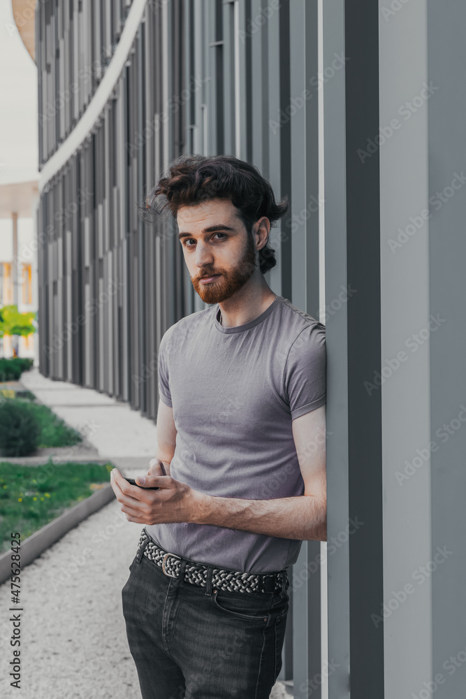 boy looking with his phone in hand