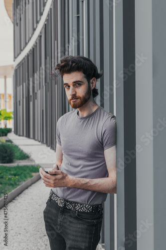 Obraz na płótnie boy looking with his phone in hand w salonie