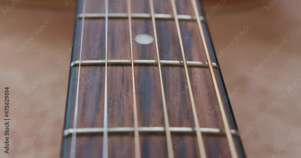 Close-up. Acoustic guitar with very shallow depth of field, emphasis on strings. Prores HQ 422, High quality. Close-up. Acoustic guitar with very shallow depth of field, emphasis on strings. Prores HQ 422, High quality.