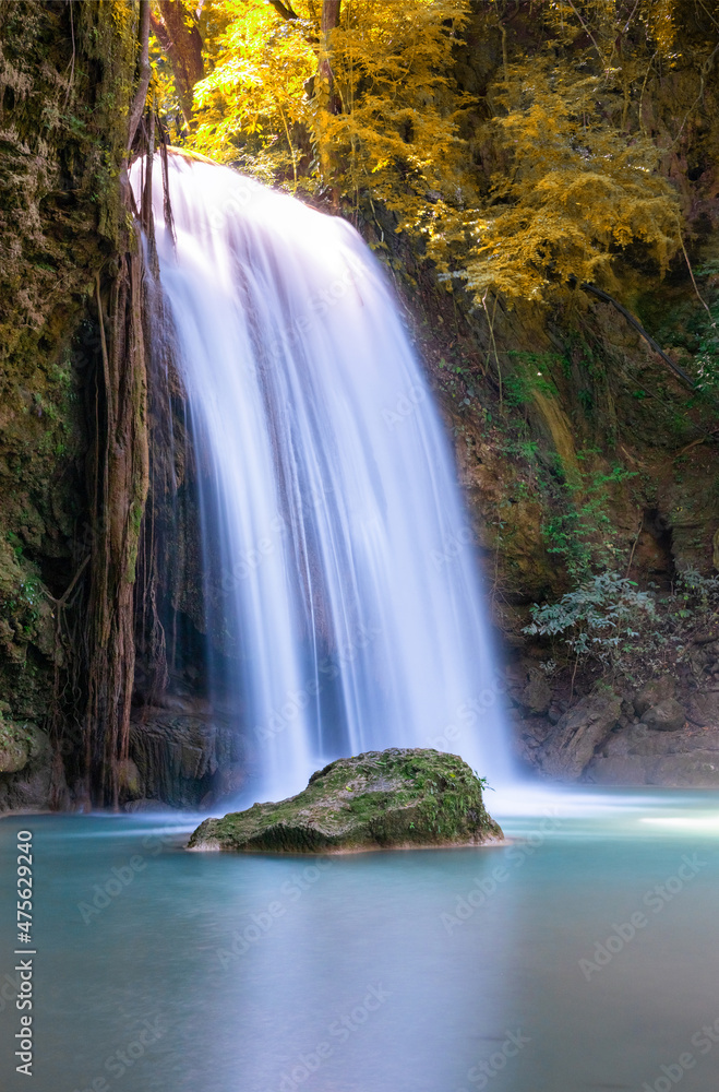 Fototapeta premium Erawan waterfalls in the national park mountains of Kanchanaburi BKK Bangkok Thailand lovely turquoise blue creamy waters lush green Autumn Leaves on trees smooth rock formations