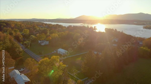 A Drone shot of a Hudson river with green trees and a valley on a sunset