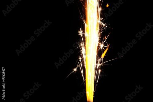 Close up of burning candle sparkler on black background