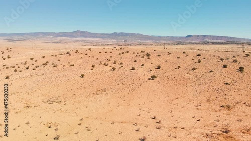 ADrone shot of a sunny dry desert in New Mexico with hills and blue sky in the background photo