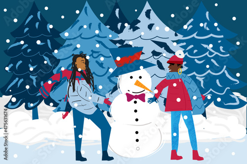 Lesbian couple building a snowman in a winter wonderland 