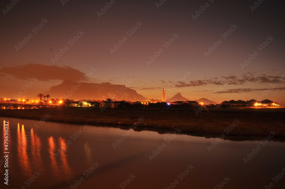 Table Mountain Panoramic Landscape with Beautiful Colorful Sunset and Streaking Clouds Landscape, Cape Town, South Africa. Sunset over the river. 