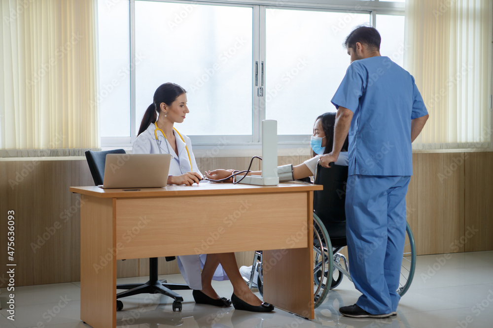 group of diverse medical team explaining X-ray results with patient on wheelchair in hospital . group of diverse medical team explaining X-ray results with patient on wheelchair in hospital .