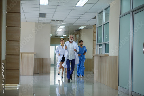 group of diverse doctor team running in hospital corridor during emergency