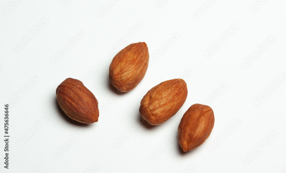 four hazelnuts on a white background four hazelnuts on a white background