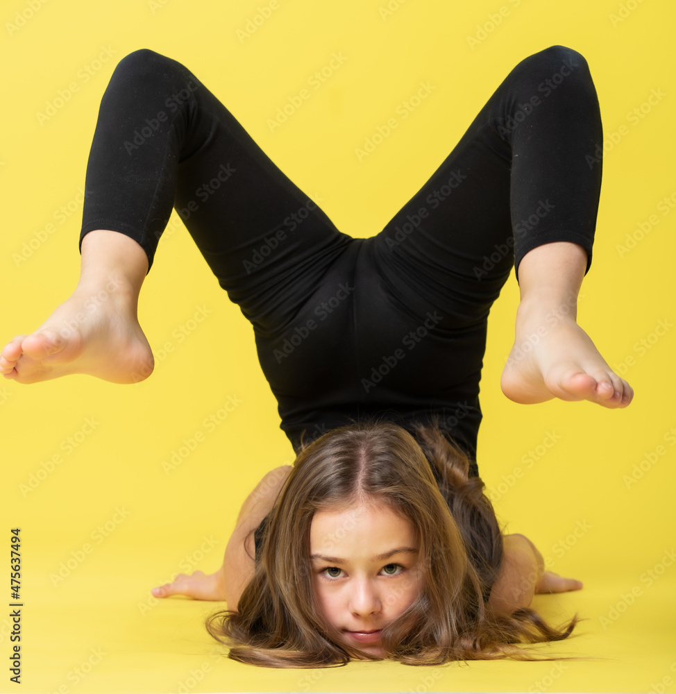 girl gymnast studio. little gymnast performs an exercise on the floor ...