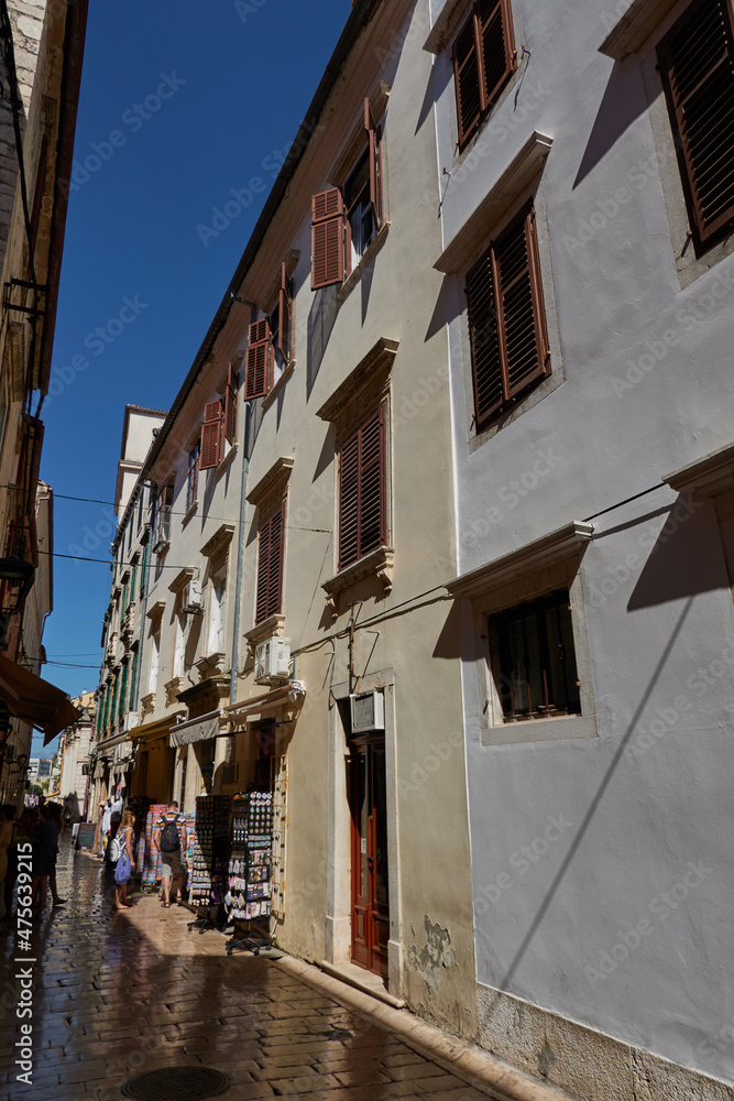 Zadar, Croatia - August 7, 2021 - narrow streets of the ancient fishing town in the summer sunny afternoon