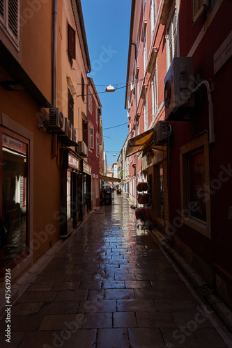 Fototapeta Naklejka Na Ścianę i Meble -  Zadar, Croatia - August 7, 2021 - narrow streets of the ancient fishing town in the summer sunny afternoon
