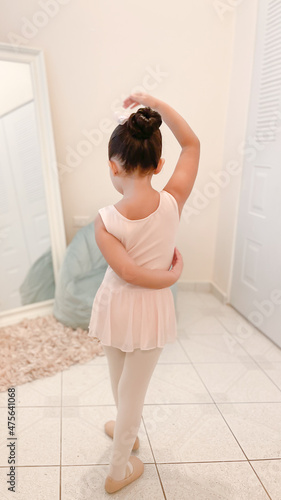 Focused little ballerina dancing: baby ballet