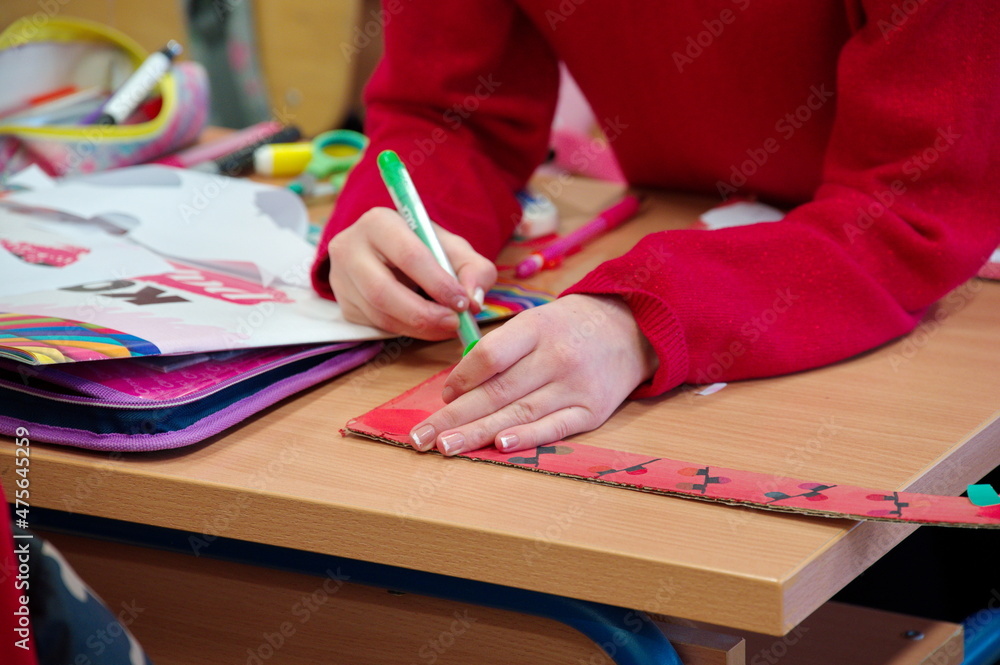 Midsection of student in classroom drawing Midsection of student in classroom drawing