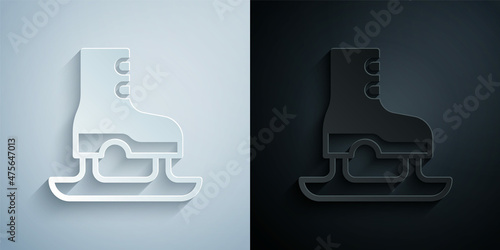 Paper cut Skates icon isolated on grey and black background. Ice skate shoes icon. Sport boots with blades. Paper art style. Vector