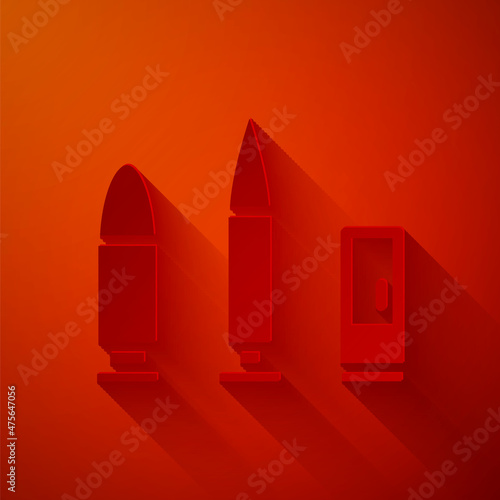 Paper cut Bullet and cartridge icon isolated on red background. Paper art style. Vector