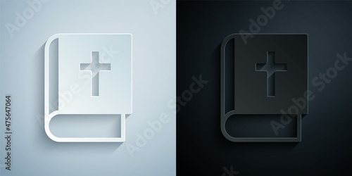 Paper cut Holy bible book icon isolated on grey and black background. Paper art style. Vector