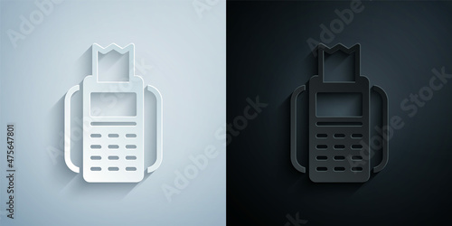Paper cut POS terminal with inserted credit card and printed reciept icon isolated on grey and black background. NFC payment concept. Paper art style. Vector