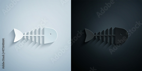 Paper cut Fish skeleton icon isolated on grey and black background. Fish bone sign. Paper art style. Vector