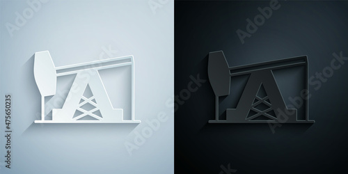 Paper cut Oil pump or pump jack icon isolated on grey and black background. Oil rig. Paper art style. Vector