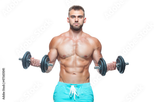 Sexy athletic man is showing muscular body with dumbbells standing with his head down, isolated over white background © satyrenko