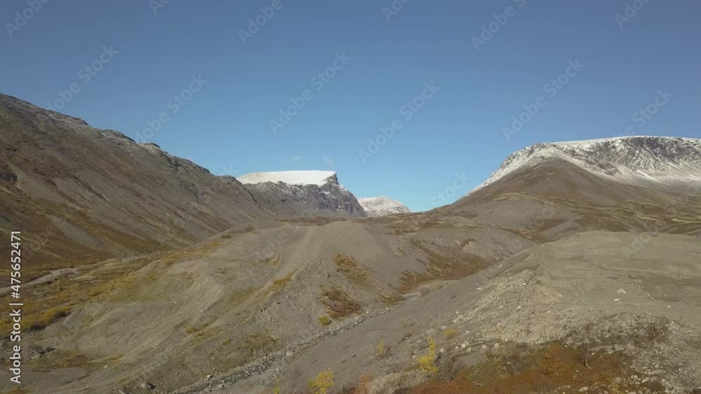 Aerial View Of The Mountainous Terrain Around, There Is Snow On Top Of The Mountains Aerial View Of The Mountainous Terrain Around, There Is Snow On Top Of The Mountains