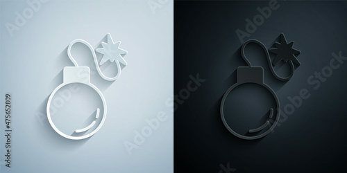 Paper cut Bomb ready to explode icon isolated on grey and black background. Paper art style. Vector