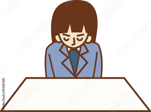 座って頭を下げるスーツを着た女性。