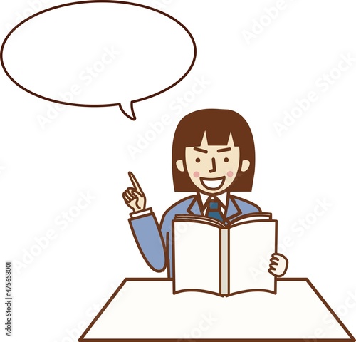本を読みながら指を差すスーツ姿の女性。