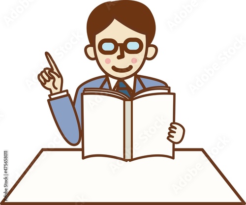 本を読みながら指を差すスーツ姿の男性。
