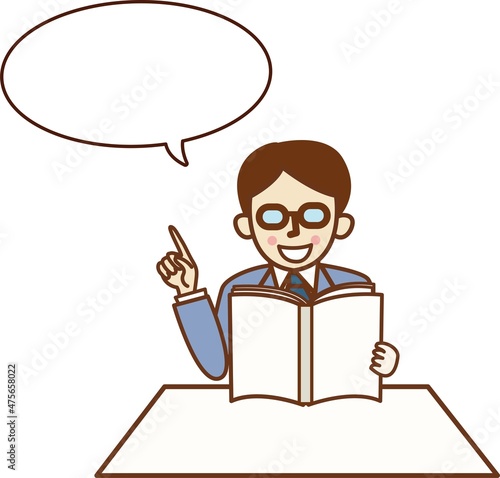本を読みながら指を差すスーツ姿の男性。