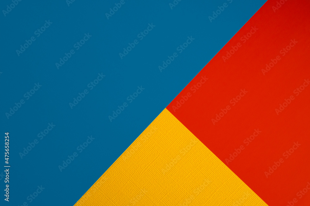 Bright abstract geometric paper background. Red, blue and orange yellow trendy colors. The backdrop for an invitation card, greeting card or web design. Creative copy space, flat lay Bright abstract geometric paper background. Red, blue and orange yellow trendy colors. The backdrop for an invitation card, greeting card or web design. Creative copy space, flat lay